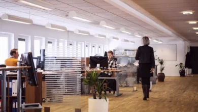 Office workers in London looking at computer screens with worried expressions