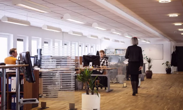 Office workers in London looking at computer screens with worried expressions