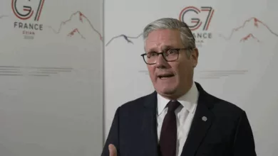 Prime Minister Keir Starmer speaking at a podium before the G7 summit in France