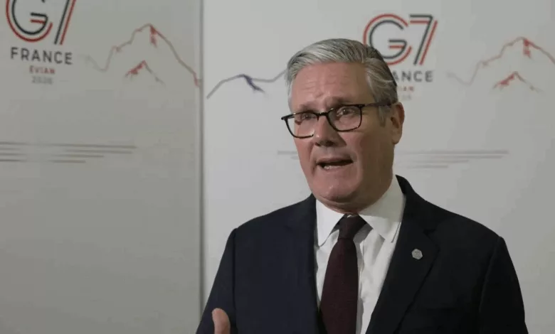 Prime Minister Keir Starmer speaking at a podium before the G7 summit in France