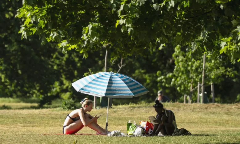 Dark storm clouds gathering over London skyline as temperatures drop sharply