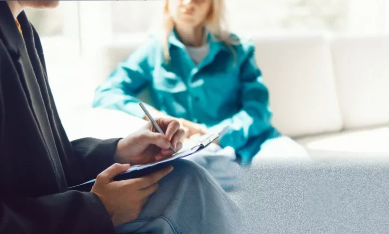 A psychiatrist conducting a semi-structured diagnostic interview with a patient in a consultation room