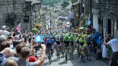Cyclists race past a Lake District fell during a stage of the Tour de France