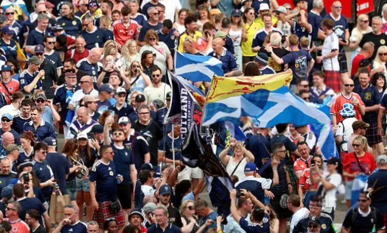 Tartan Army fans in kilts celebrating on the concourse at Fenway Park