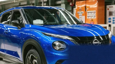 New electric cars parked in a showroom with UK flags in the background