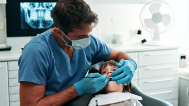 Close-up of a child's discoloured and chipped permanent molars in a dental clinic