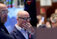 A screen on a trading floor showing a sharp drop on the Nasdaq Composite index.
