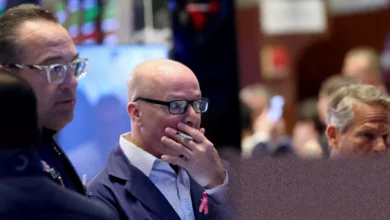 A screen on a trading floor showing a sharp drop on the Nasdaq Composite index.