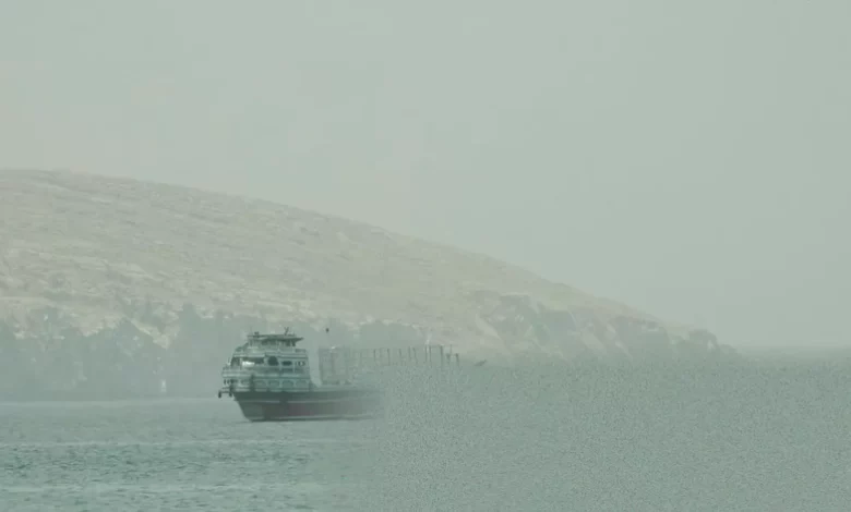 Aerial view of the Strait of Hormuz with commercial shipping lanes visible