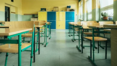 Pupils crouch under classroom desks during a lockdown drill at a UK secondary school.