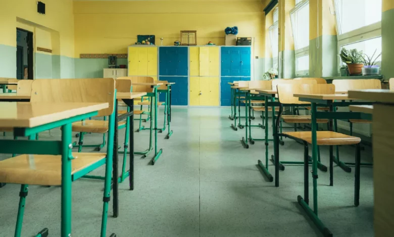 Pupils crouch under classroom desks during a lockdown drill at a UK secondary school.