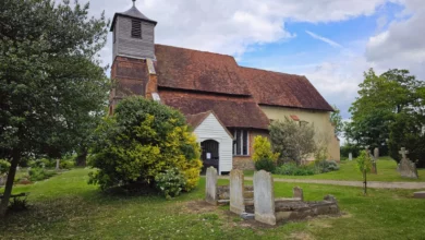 Medieval stone church standing alone in a field near the River Wid in Essex