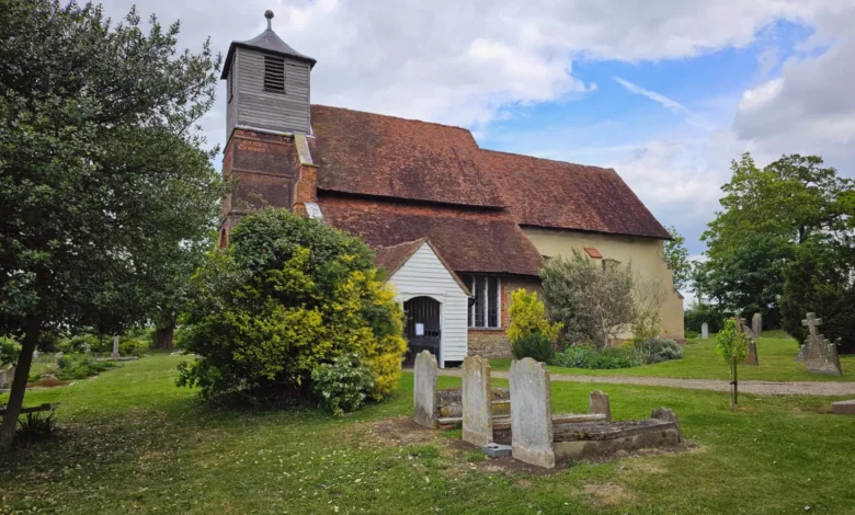 Medieval stone church standing alone in a field near the River Wid in Essex