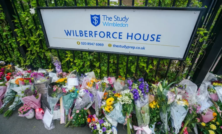 Police vehicles outside a primary school in Wimbledon following a fatal crash