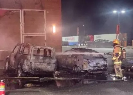 Sleeping passengers escaping from a car moments before it was engulfed in flames at a petrol station.