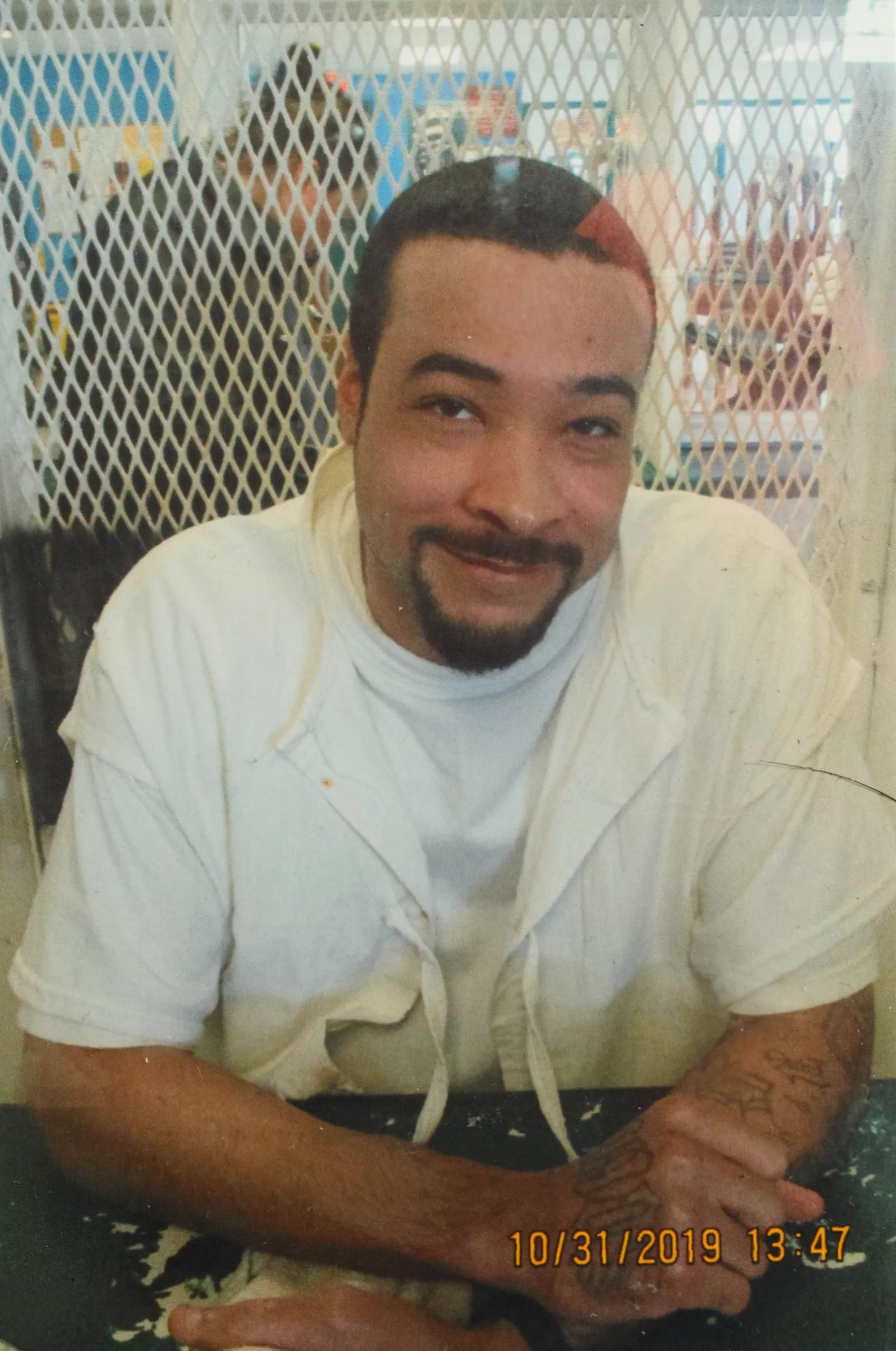 A prison chaplain standing near a gurney in an empty execution chamber