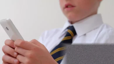Secondary school students in a classroom without mobile phones under new ban rules