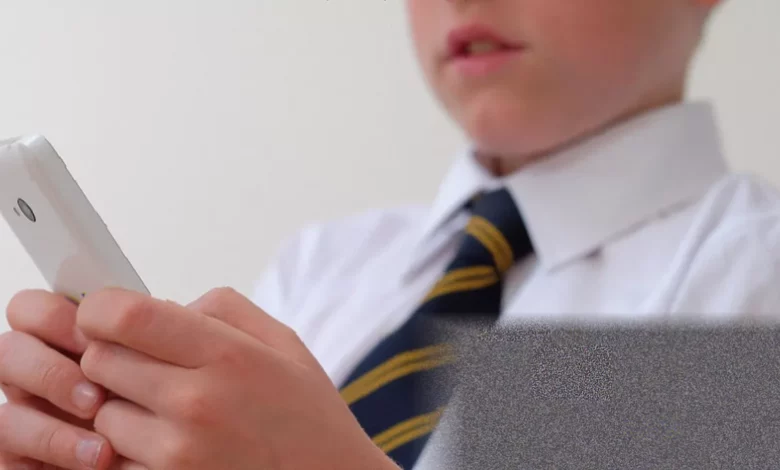 Secondary school students in a classroom without mobile phones under new ban rules
