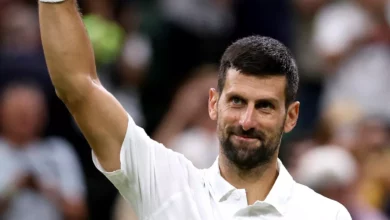 Novak Djokovic serving on Centre Court at Wimbledon during a third-round match.