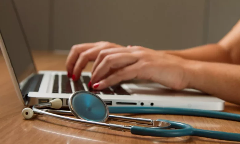 A clinician using a tablet with an AI documentation interface in a private practice treatment room