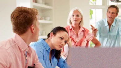 A parent looking at a closed bedroom door in a quiet home