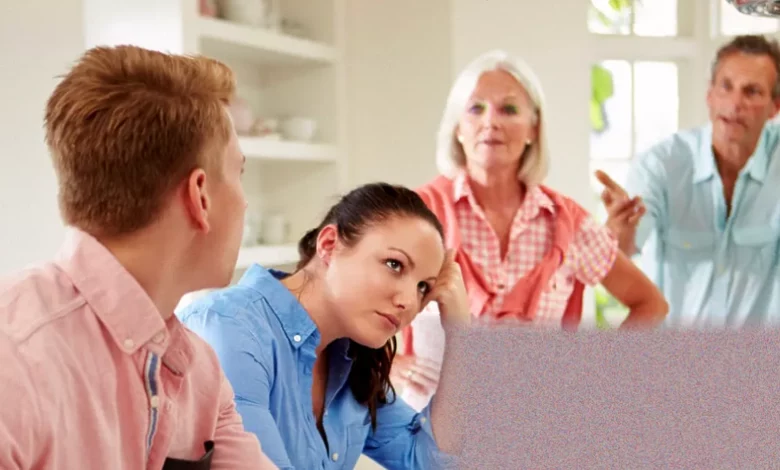 A parent looking at a closed bedroom door in a quiet home