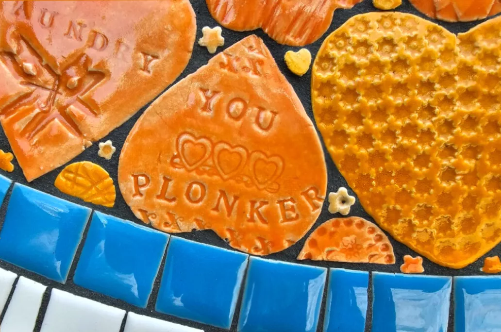 Community mosaic on the Mildmay line platform featuring local landmark names