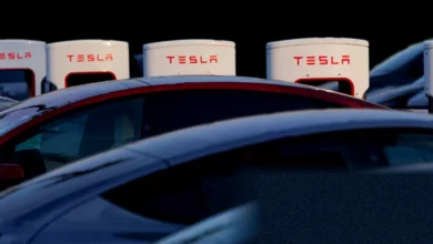 A row of new Tesla vehicles lined up for delivery at a European showroom