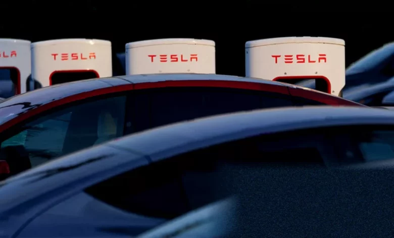 A row of new Tesla vehicles lined up for delivery at a European showroom