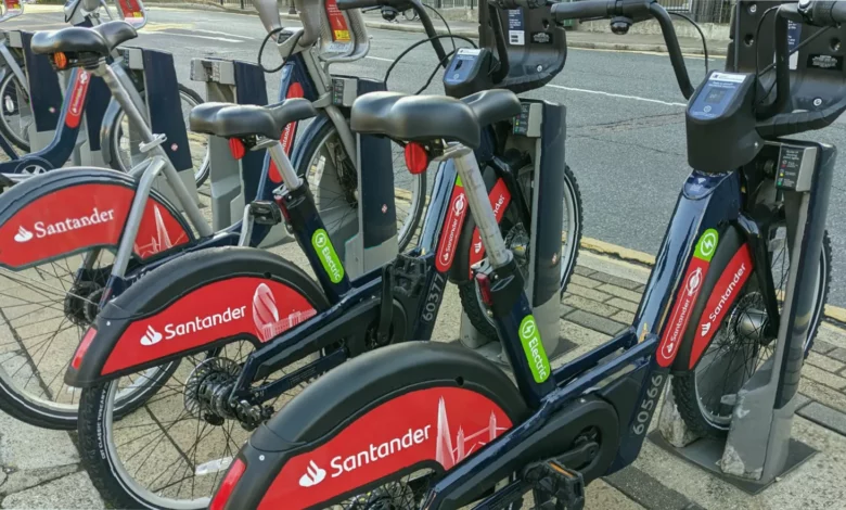 Rows of red Santander hire bikes at a London docking station