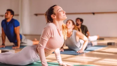 Yoga class in a community centre with attendees of mixed ages and ethnicities